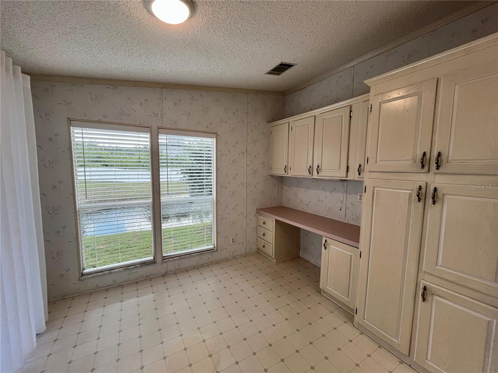10614 Hayden Avenue New Port Richey, FL 34655 - Photo 6 of 23 a view of a kitchen with a sink cabinets and a window