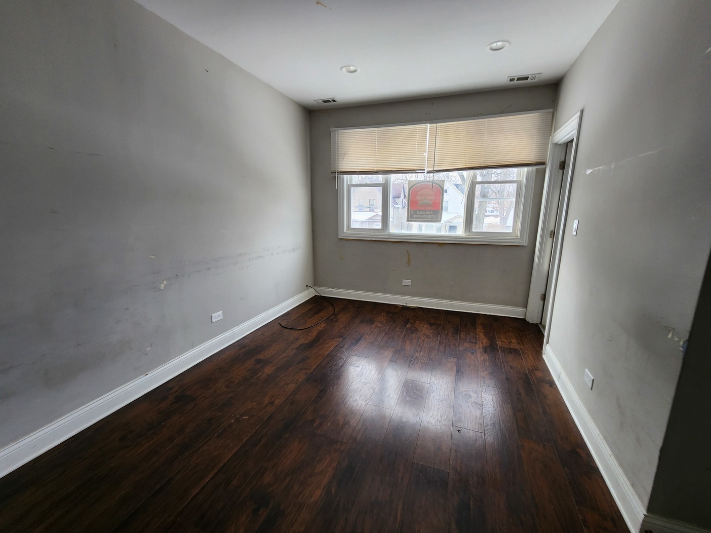 12211 South Wallace Street Chicago, IL 60628 - Photo 12 of 17 an empty room with wooden floor and windows