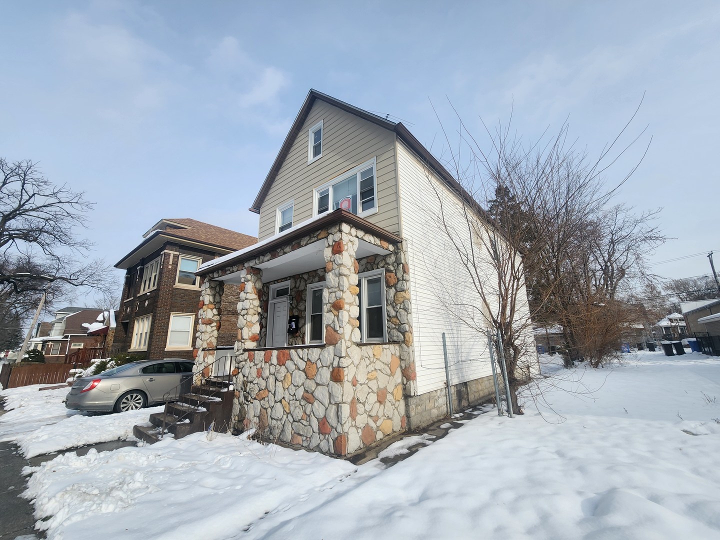 12211 South Wallace Street Chicago, IL 60628 - Photo 2 of 17 a front view of a house with a yard covered in snow