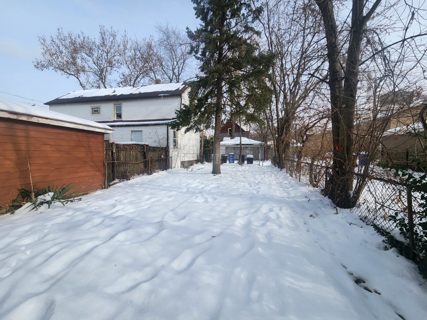 12211 South Wallace Street Chicago, IL 60628 - Photo 3 of 17 a view of a house with a snow in the yard