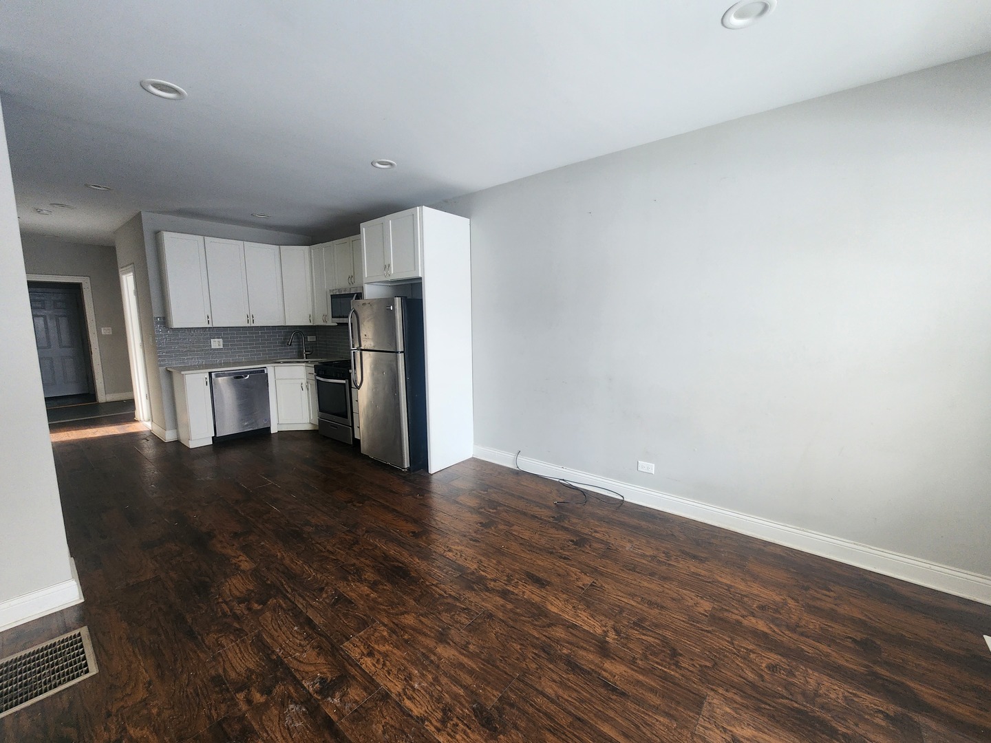 12211 South Wallace Street Chicago, IL 60628 - Photo 6 of 17 a kitchen with a refrigerator and a stove top oven