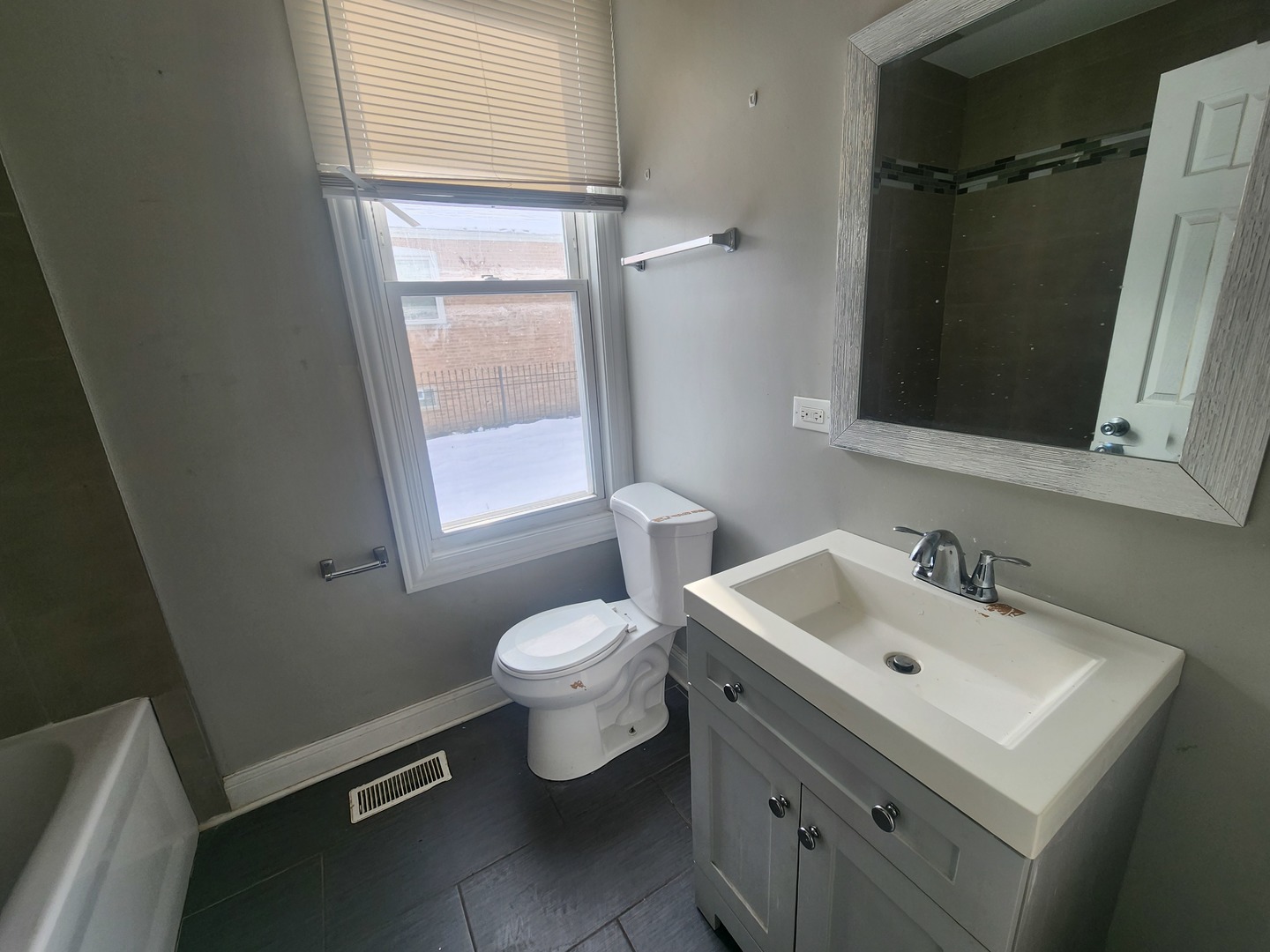 12211 South Wallace Street Chicago, IL 60628 - Photo 10 of 17 a bathroom with a sink toilet and mirror