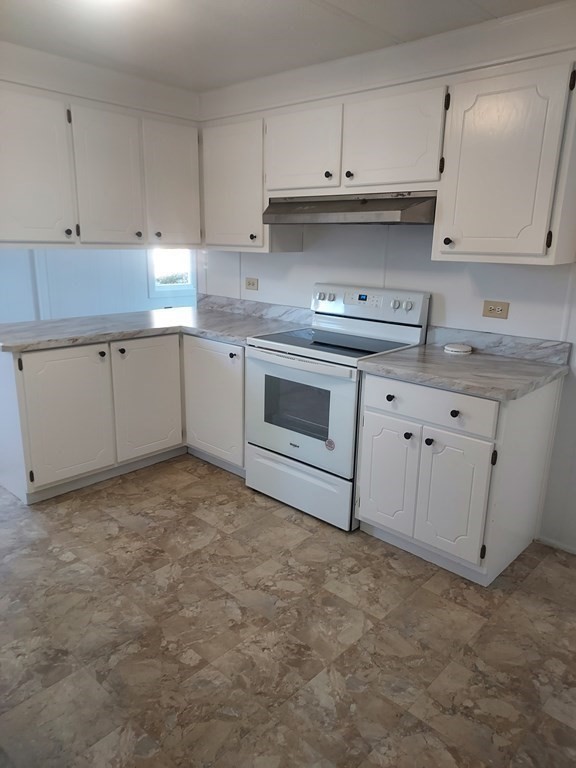 61 Longboat Road West Wareham, MA 02576 - Photo 8 of 15 a kitchen with granite countertop a stove a sink and a refrigerator