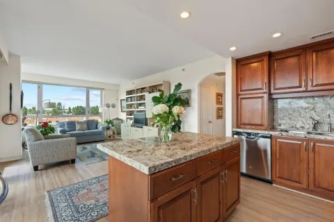 a kitchen with a stove and a living room