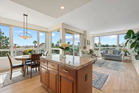 a kitchen with kitchen island granite countertop a table and chairs