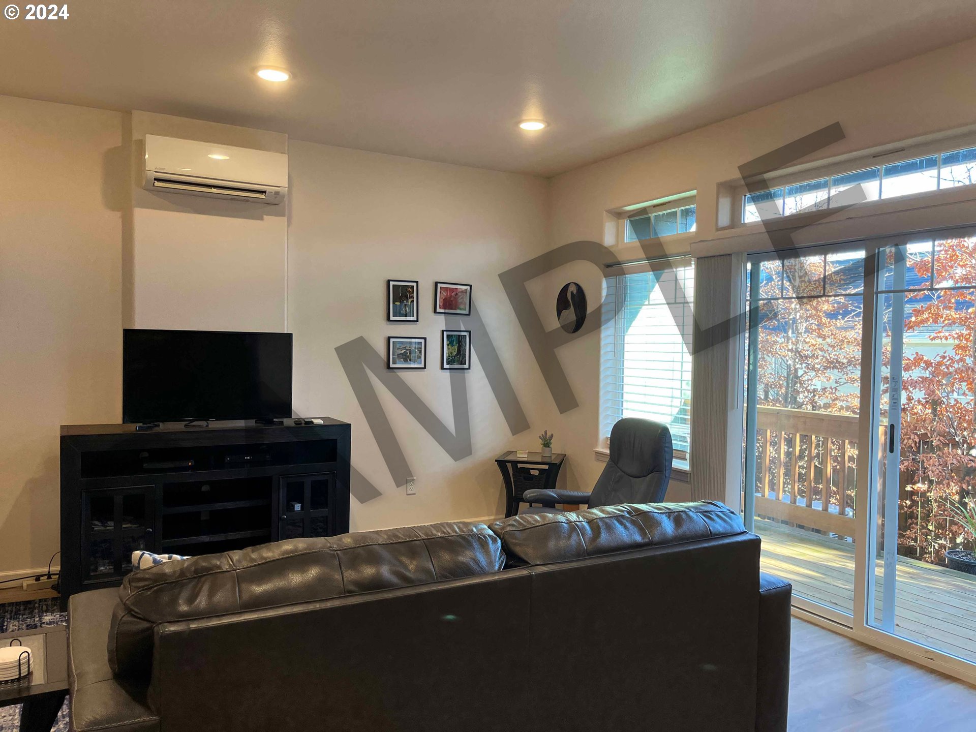 1595 37th Street Florence, OR 97439 - Photo 24 of 48 a living room with furniture a flat screen tv and a fireplace