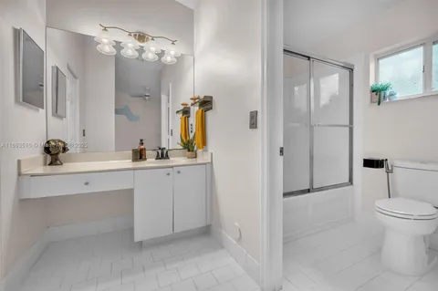 a spacious bathroom with a double vanity sink mirror and toilet