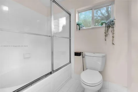 a white toilet sitting next to a window