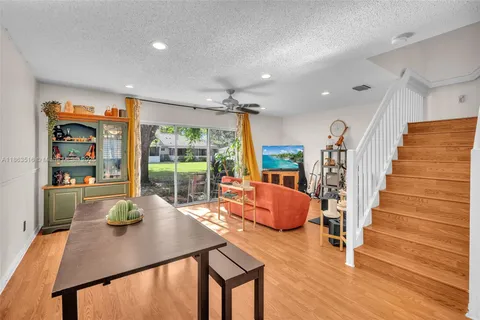 a living room with furniture a rug and white walls