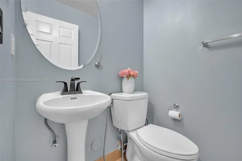 a white toilet sitting next to a bathroom sink