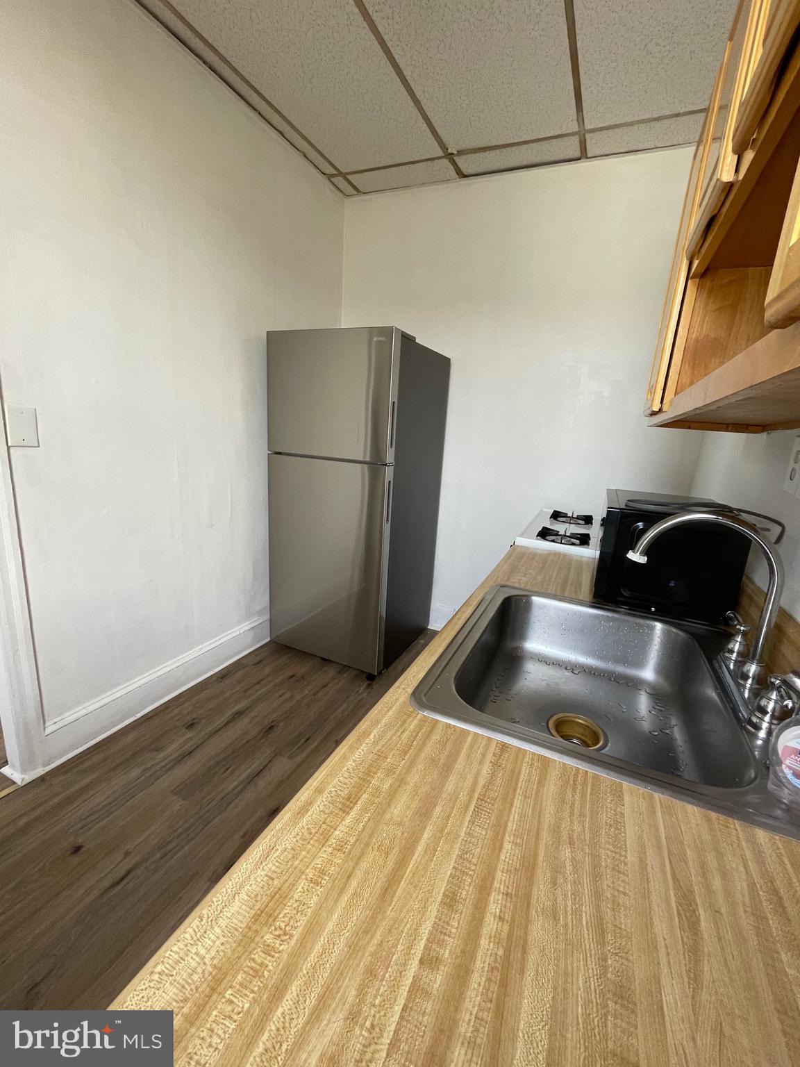 1426 Snyder Avenue Philadelphia, PA 19145 - Photo 11 of 16 a kitchen with a sink and refrigerator