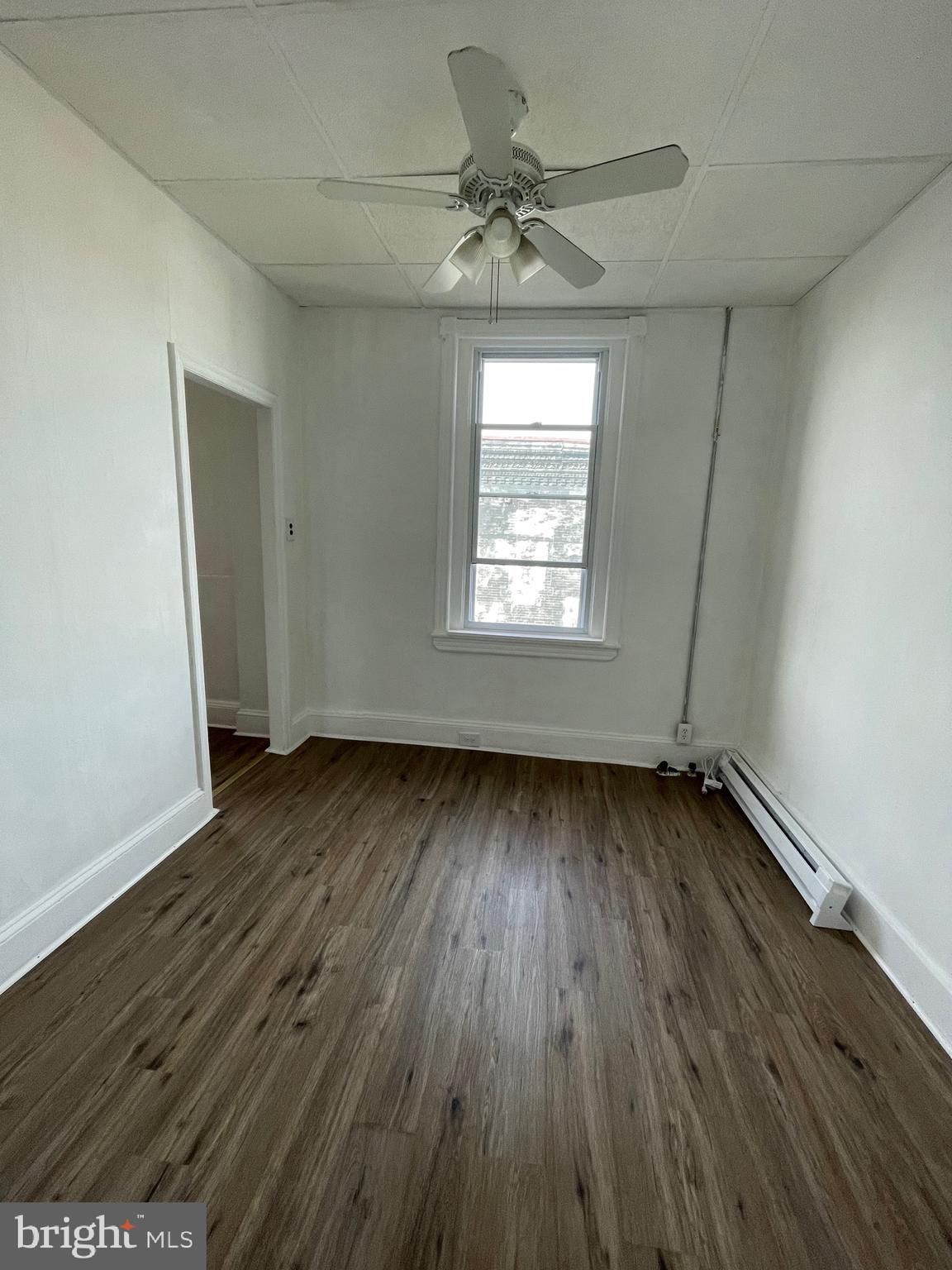 1426 Snyder Avenue Philadelphia, PA 19145 - Photo 14 of 16 an empty room with wooden floor and windows