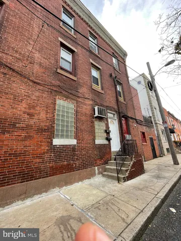 a view of a brick building with many windows