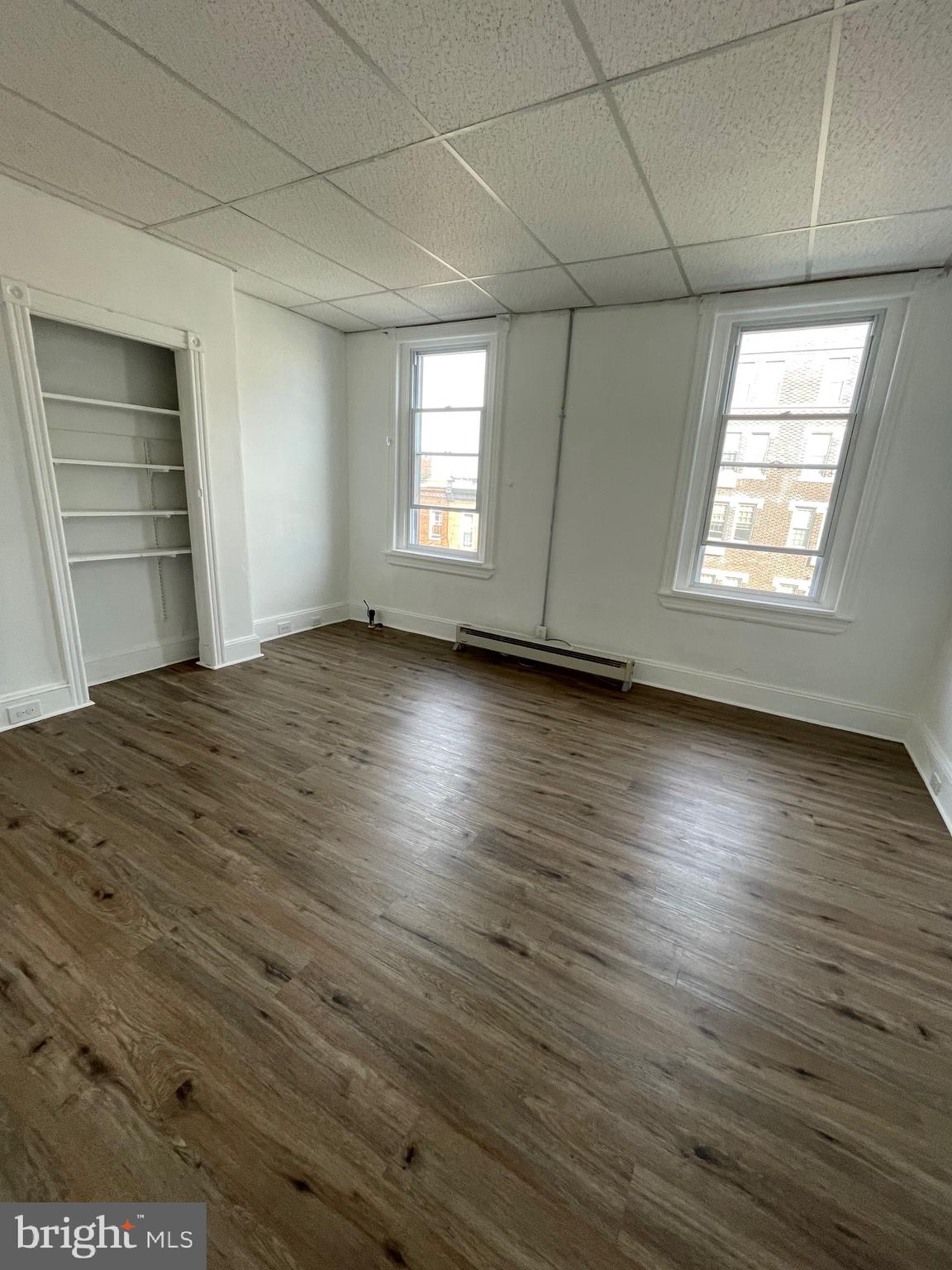 1426 Snyder Avenue Philadelphia, PA 19145 - Photo 10 of 16 an empty room with wooden floor and windows