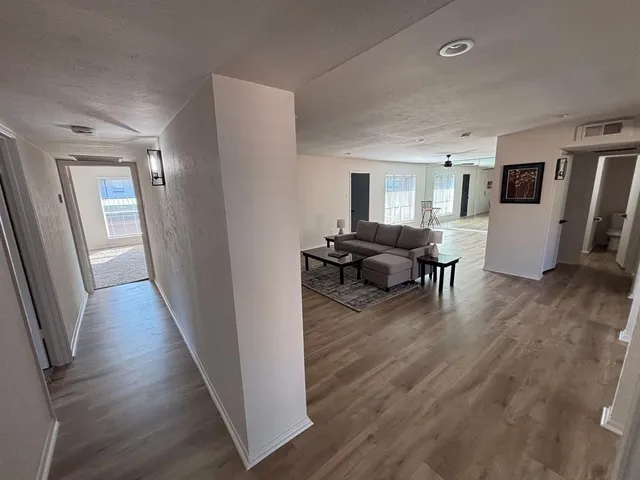 a view of a room with wooden floor and stairs