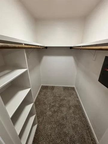 a view of bathroom with a toilet and a mirror