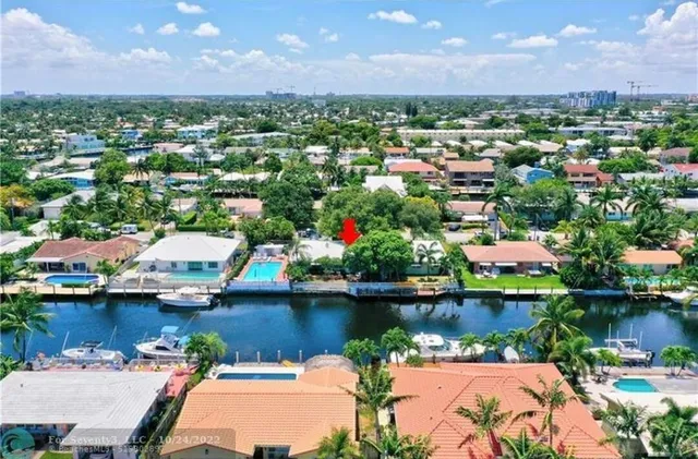 an aerial view of residential houses with outdoor space and lake view