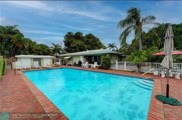a view of a backyard with furniture and a garden