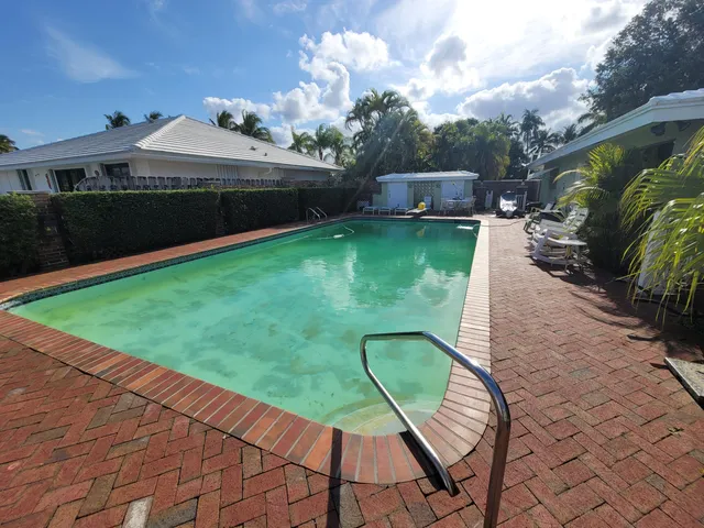 a view of a patio with couches table and chairs and potted plants