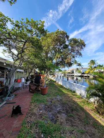 an outdoor view of a house with a garden and parking space