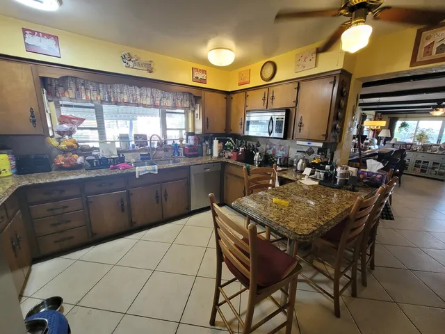 a kitchen with a stove a sink and a refrigerator