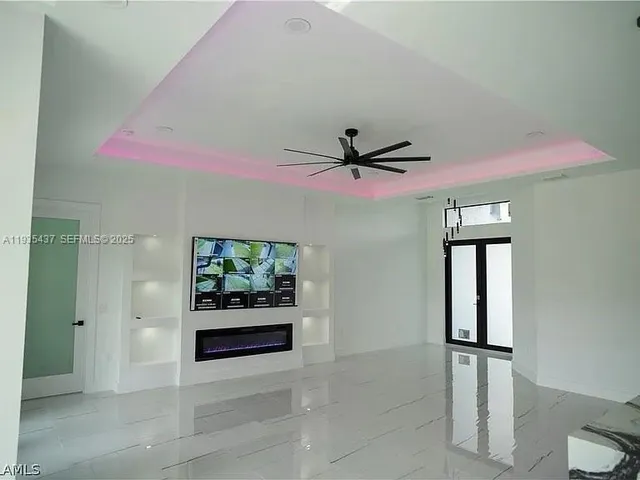 a view of a hallway with a window and a ceiling fan