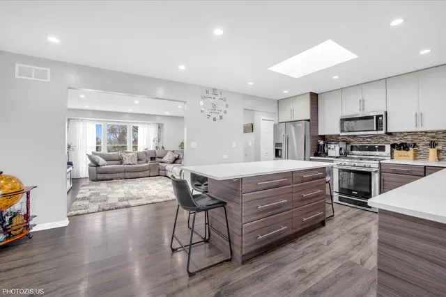 a view of a room with furniture and wooden floor