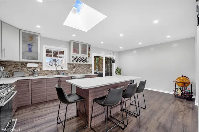 a kitchen with stainless steel appliances granite countertop a refrigerator and a stove top oven