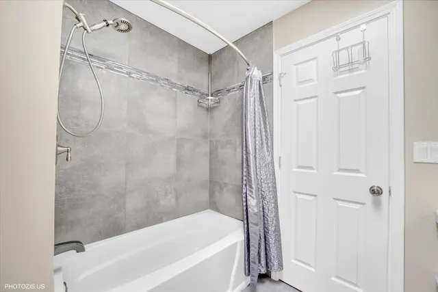 a spacious bedroom with a bed and a mirror