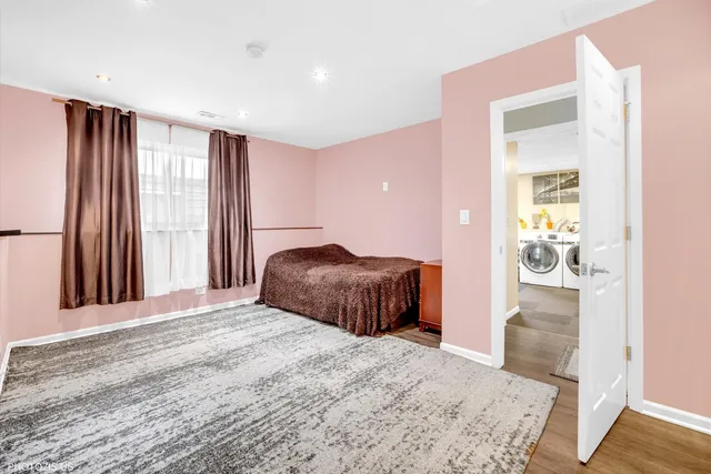 a utility room with multiple dryer washer and closet