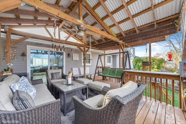a view of a house with a big yard plants and large tree