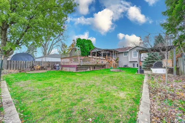 a view of a house with a yard and sitting area