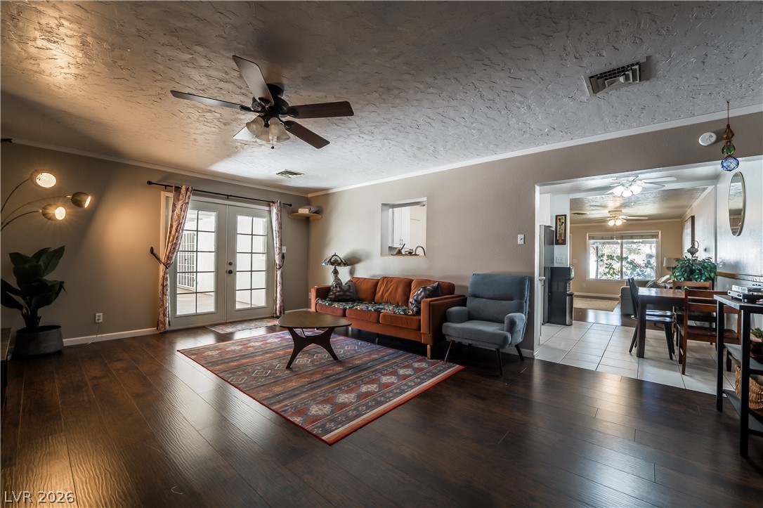1324 Appaloosa Road Boulder City, NV 89005 - Photo 13 of 42 Rich hardwood floors complement this cozy living space, opening to a sun-drenched patio through French doors.