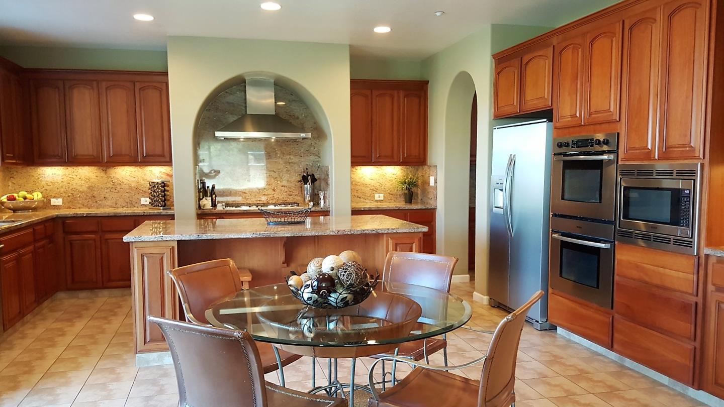 7271 Eagle Ridge Drive Gilroy, CA 95020 - Photo 9 of 17 a kitchen with a table chairs refrigerator and microwave