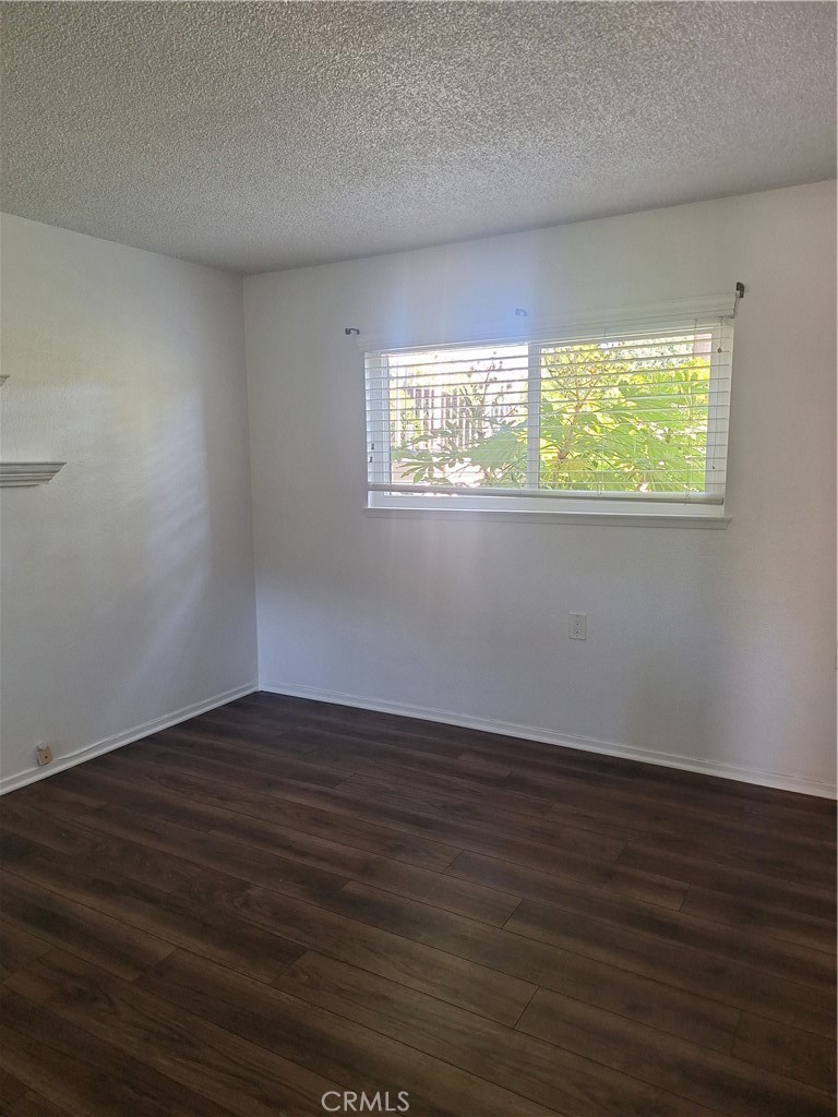 2139-unit A Ronda Granada, Unit A Laguna Woods, CA 92637 - Photo 7 of 8 a view of an empty room with wooden floor and a window