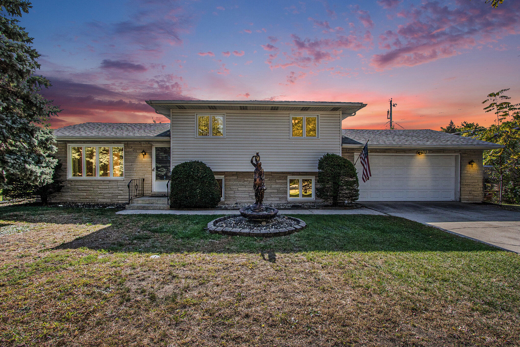 a front view of a house with garden