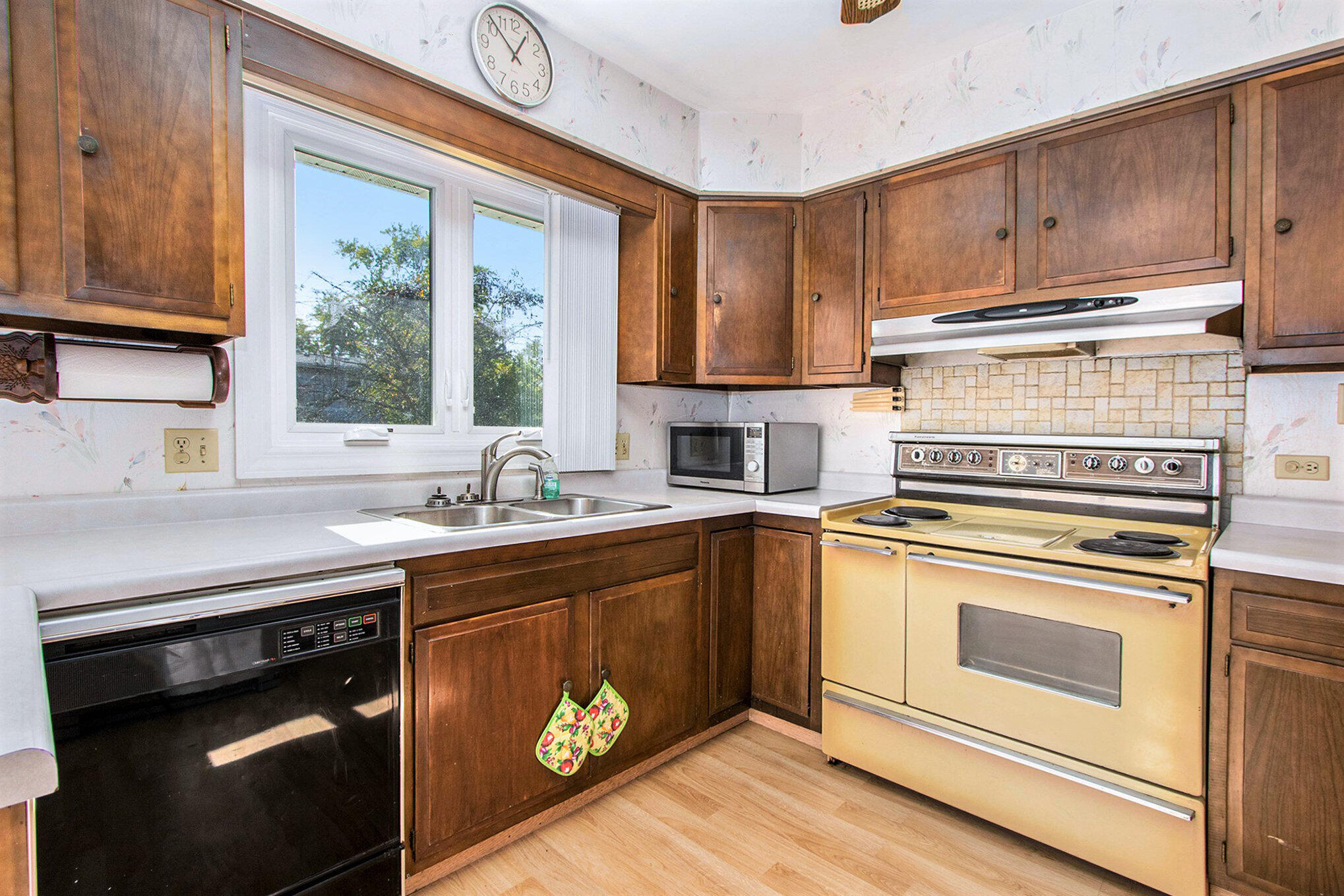 1803 West 95th Court Crown Point, IN 46307 - Photo 12 of 26 a kitchen with stainless steel appliances granite countertop a stove a sink and a microwave
