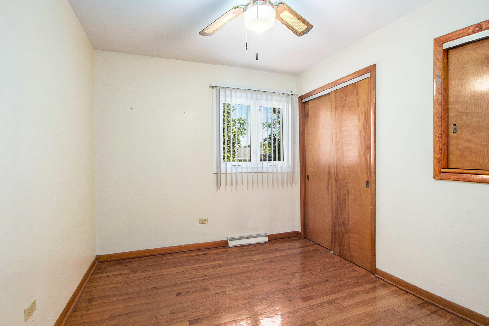 1803 West 95th Court Crown Point, IN 46307 - Photo 13 of 26 an empty room with wooden floor and windows