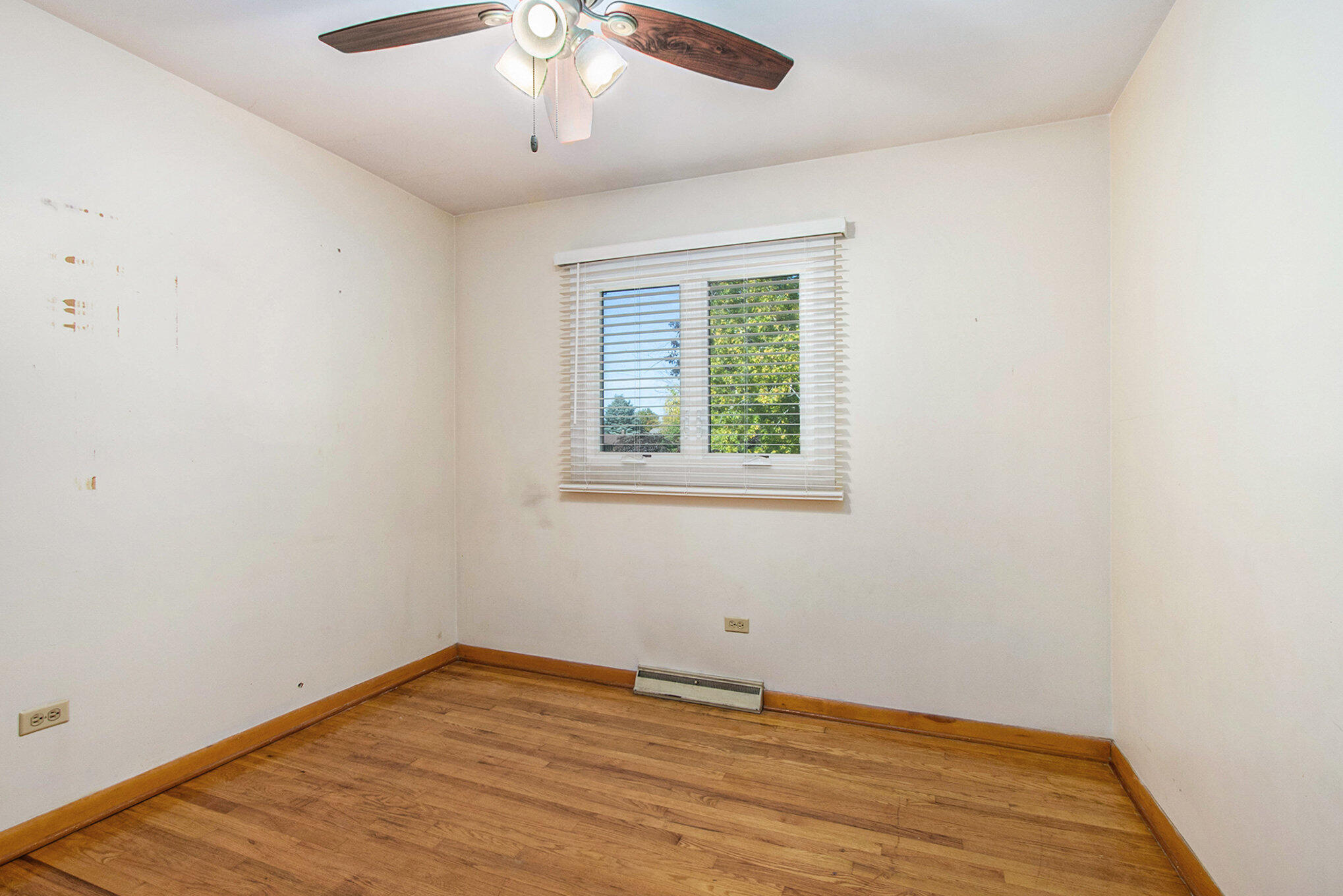 1803 West 95th Court Crown Point, IN 46307 - Photo 15 of 26 an empty room with wooden floor and windows