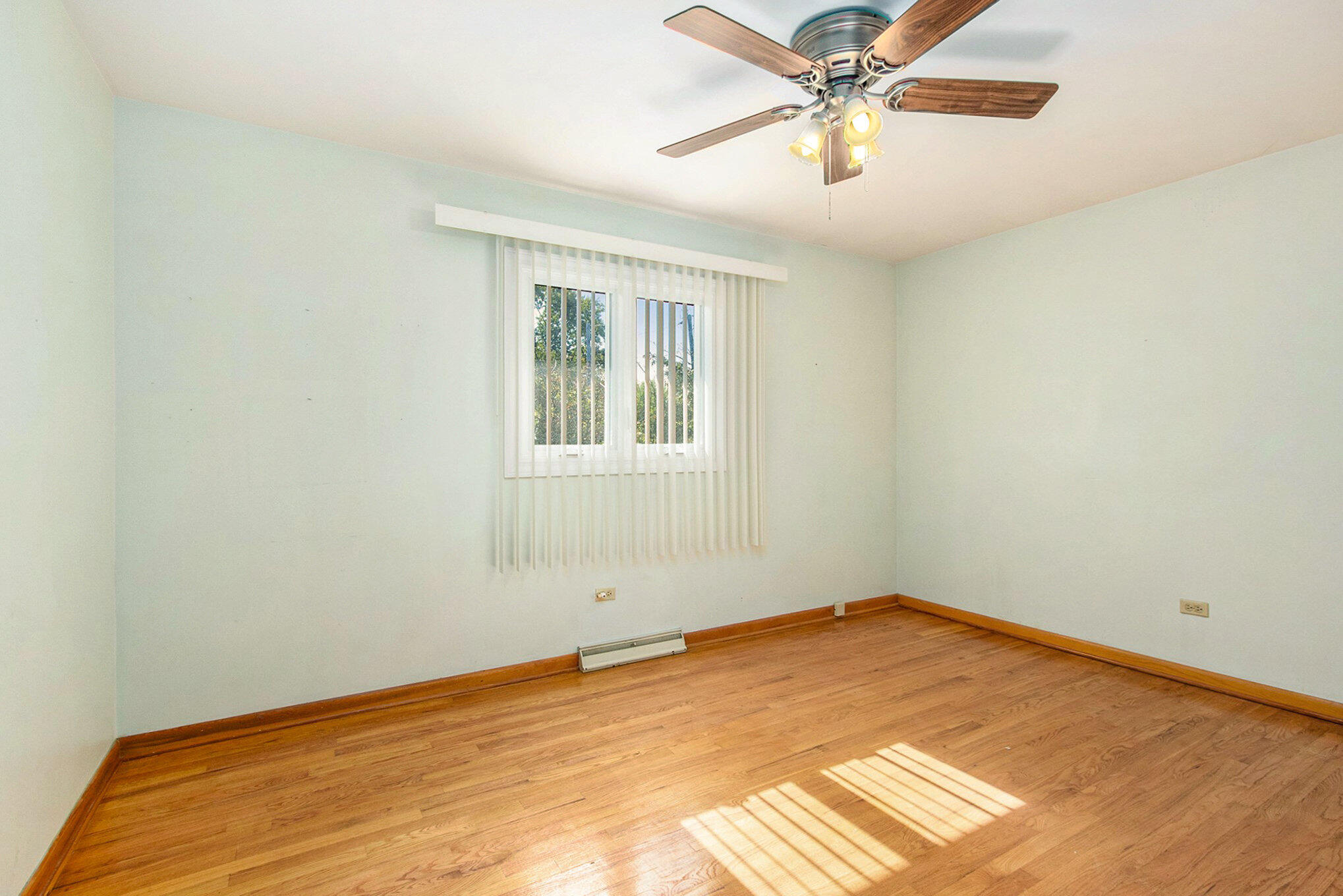 1803 West 95th Court Crown Point, IN 46307 - Photo 16 of 26 a view of a room with wooden floor and a ceiling fan