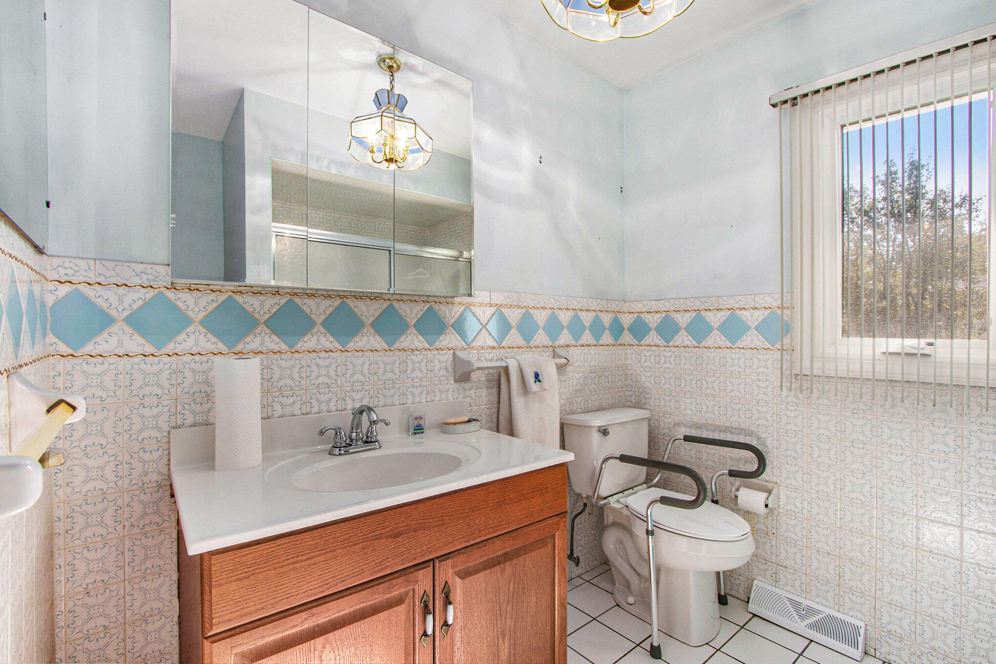 1803 West 95th Court Crown Point, IN 46307 - Photo 17 of 26 a bathroom with a sink toilet and mirror