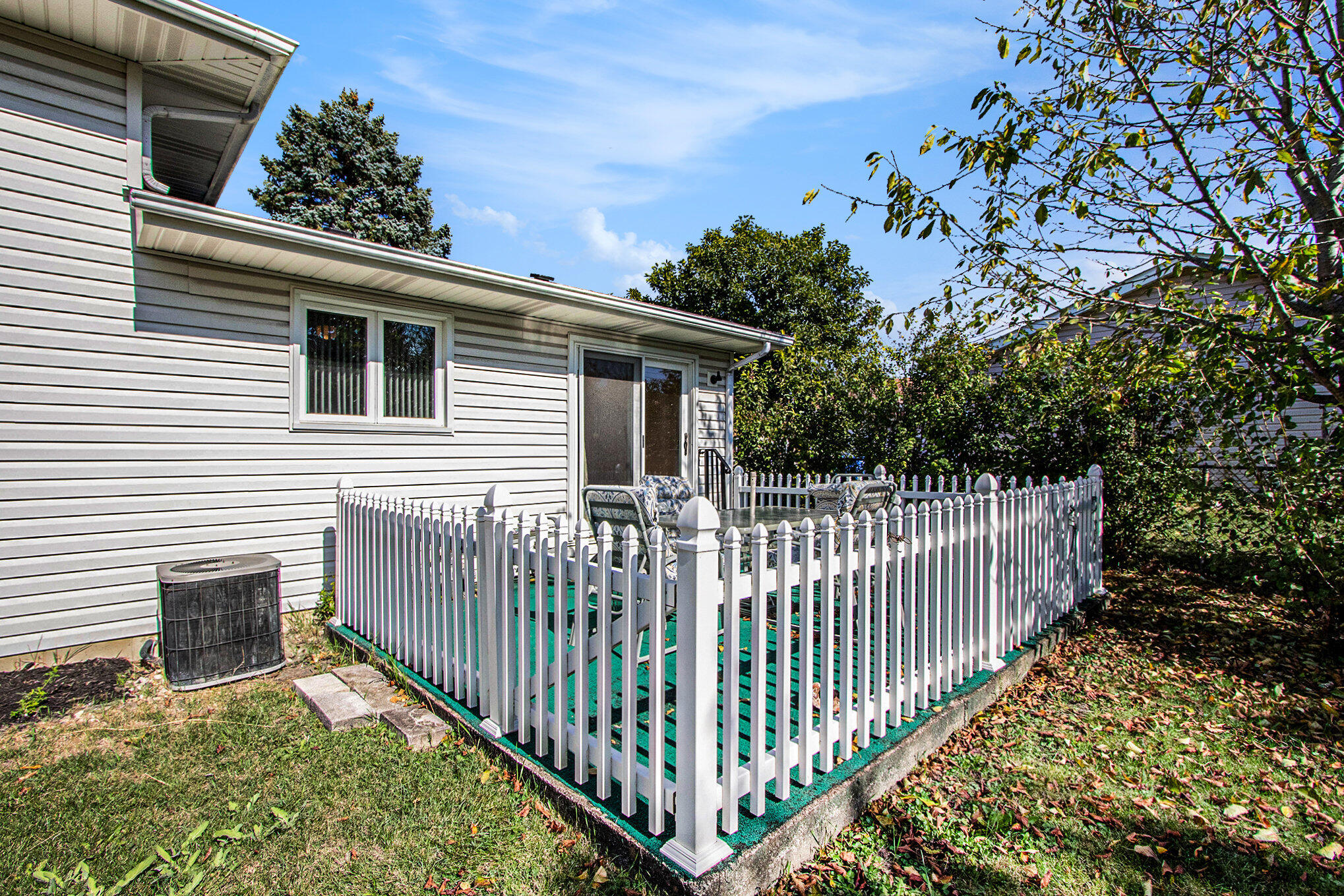 1803 West 95th Court Crown Point, IN 46307 - Photo 24 of 26 a view of a house with a small yard and deck