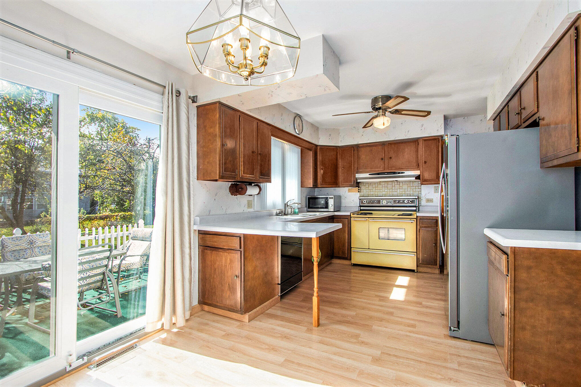 1803 West 95th Court Crown Point, IN 46307 - Photo 10 of 26 a kitchen with stainless steel appliances granite countertop a stove top oven a refrigerator a sink and dishwasher with wooden floor