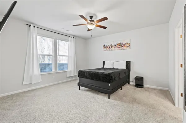 a bedroom with a bed and window