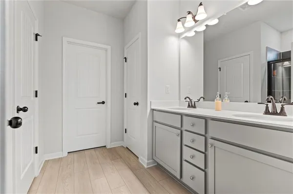a bathroom with a double vanity sink mirror and