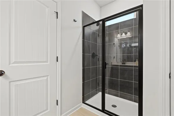 a bathroom with a glass shower door