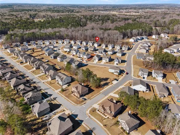 an aerial view of residential houses with outdoor space
