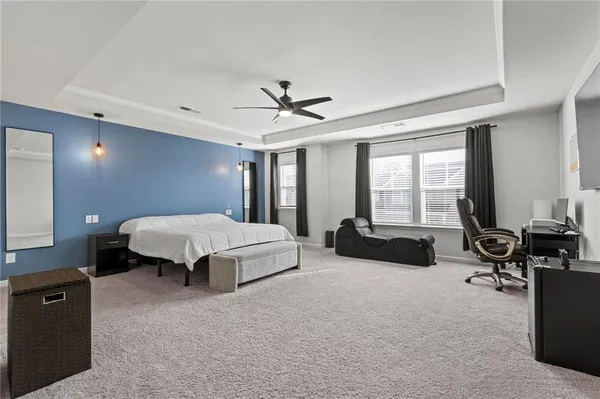 a spacious bedroom with a bed and a couch