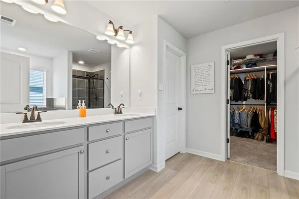 a bathroom with a sink vanity and a mirror