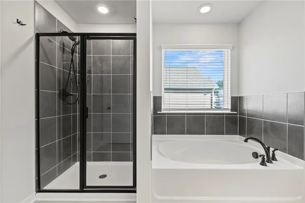 a bathroom with a shower and a bathtub